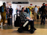 Billings resident Tina Gellos travels to her gate using an autonomous wheelchair at Seattle-Tacoma International Airport on Oct. 3, 2024.