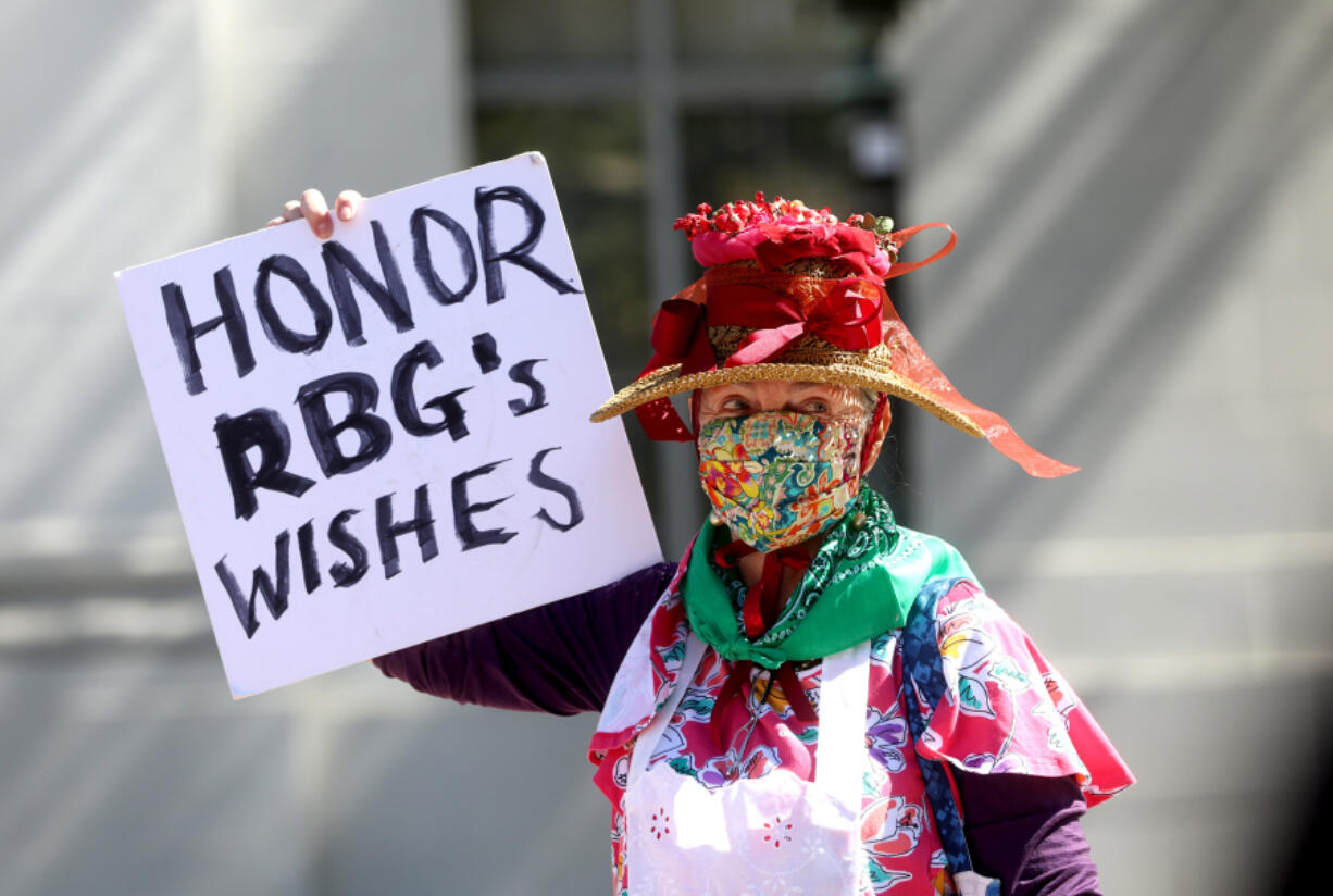 A demonstrator holds a  sign during a protest in favor of abortion rights on the steps of Sproul Hall on the University of California Berkeley campus on March 8, 2022, in Berkeley, California.