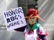 A demonstrator holds a  sign during a protest in favor of abortion rights on the steps of Sproul Hall on the University of California Berkeley campus on March 8, 2022, in Berkeley, California.