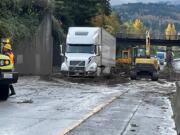 A semi trailer truck is stuck in a mudslide on Interstate 5 near a pedestrian crossing north of the Iowa Street overpass. The driver was uninjured, the Bellingham Fire Department said.