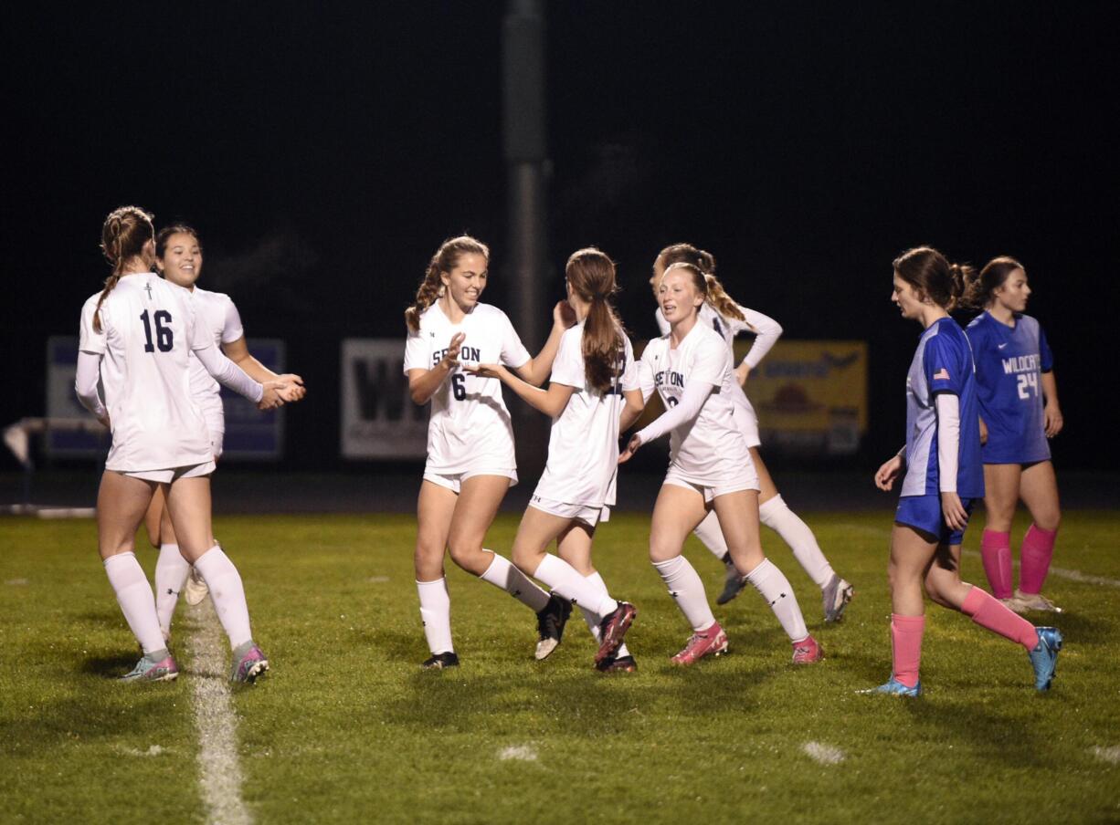 Seton Catholic's Lilah Chase (6) celebrates with teammates after scoring a goal against La Center in a Trico League girls soccer game on Tuesday, Oct. 29, 2024, at La Center High School.