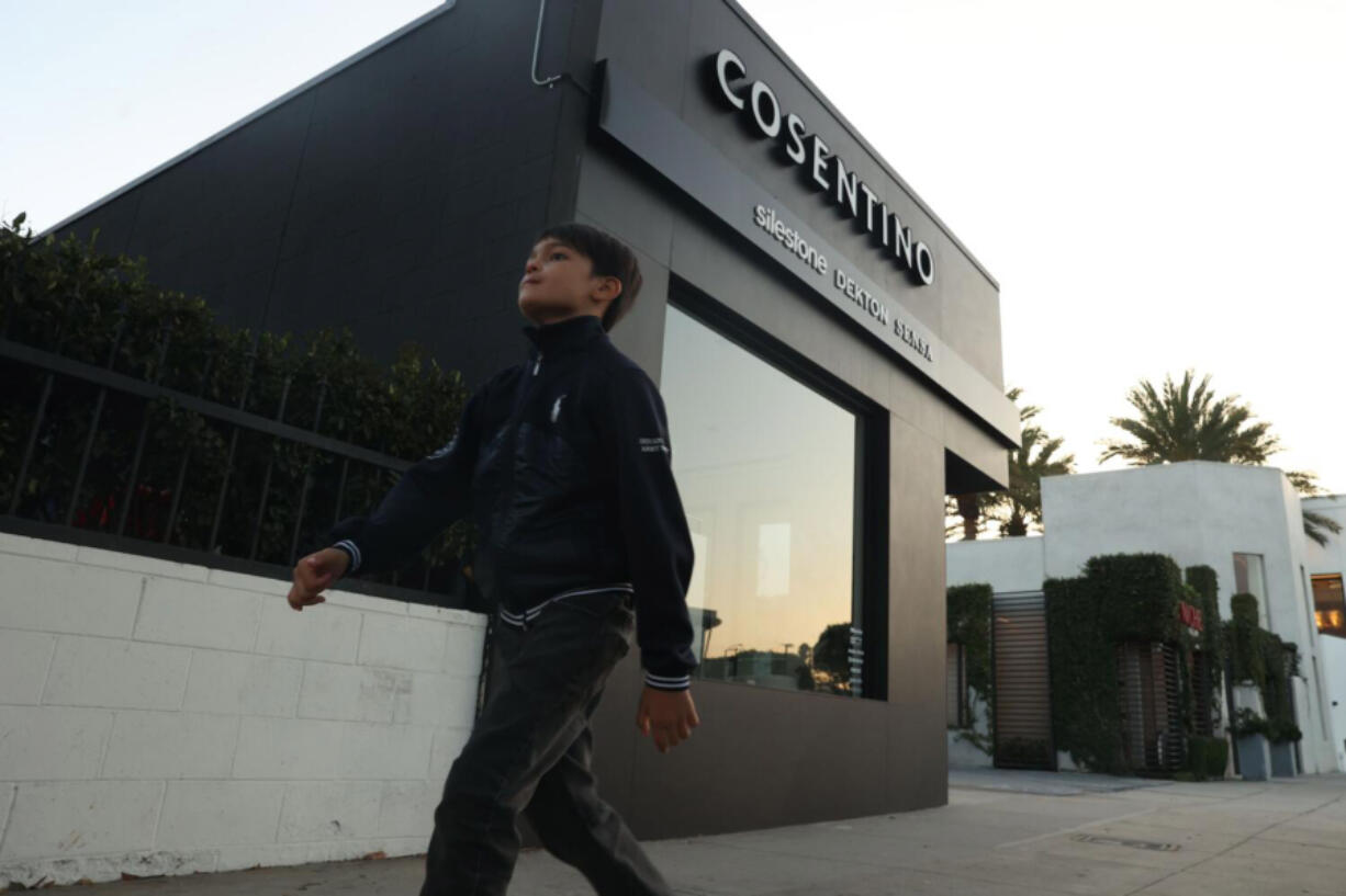 A young boy walks by the Cosentino store on Monday, Oct. 14, 2024 in Los Angeles, Calif.