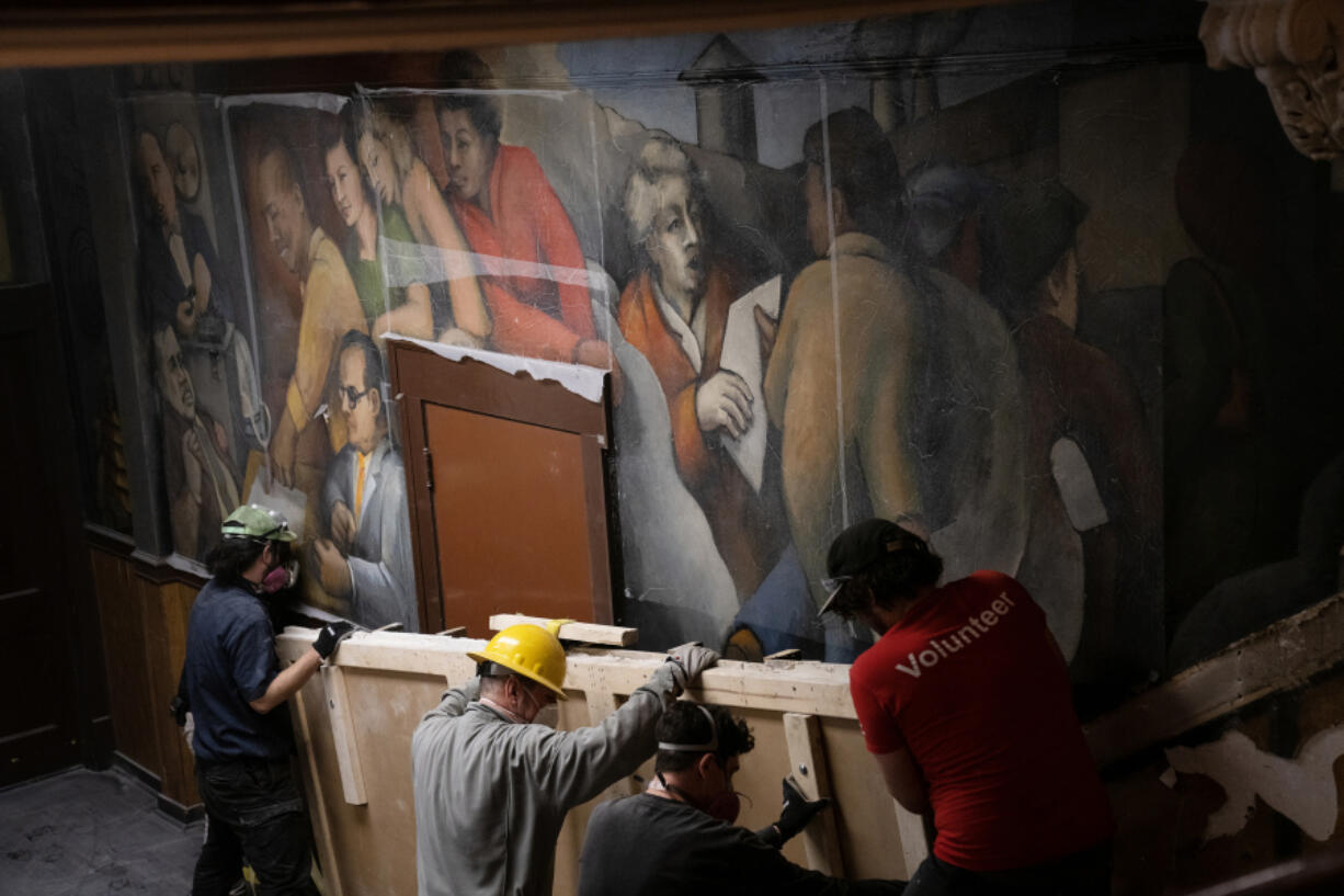 A crew from Terry Dowd removes a section of the &ldquo;Solidarity&rdquo; mural March 4 on the interior walls of the United Electrical, Radio &amp; Machine Workers of America union hall in Chicago. (E.