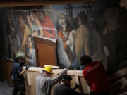 A crew from Terry Dowd removes a section of the &ldquo;Solidarity&rdquo; mural March 4 on the interior walls of the United Electrical, Radio &amp; Machine Workers of America union hall in Chicago. (E.