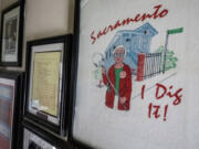 A framed &ldquo;Sacramento &mdash; I dig it!&rdquo; T-shirt depicting notorious Sacramento serial killer Dorothea Puente hangs amid other memorabilia about the case on the wall of her former F Street home on Oct. 18.