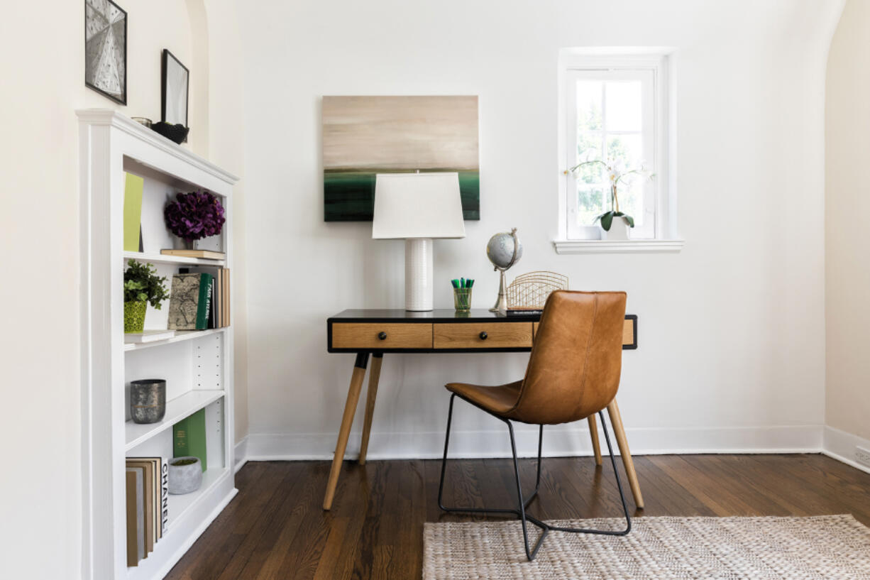 A simple desk and chair creates a functional place to work in this home.