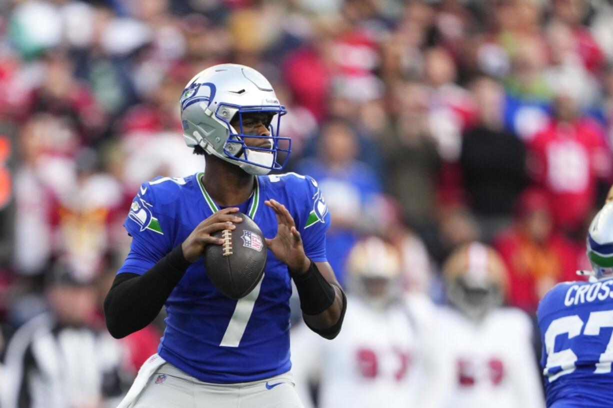 Seattle Seahawks quarterback Geno Smith looks to throws during the first half of an NFL football game against the San Francisco 49ers, Thursday, Oct. 10, 2024, in Seattle.