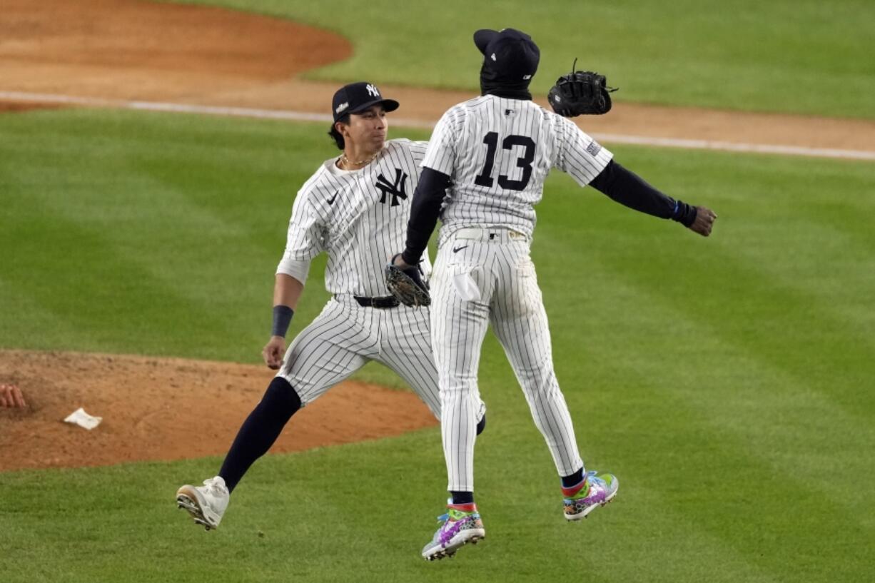 New York Yankees&#039; Jazz Chisholm Jr. (13) and Oswaldo Cabrera celebrate after Game 1 of the baseball AL Championship Series against the Cleveland Guardians Monday, Oct. 14, 2024, in New York. The Yankees won 5-2.