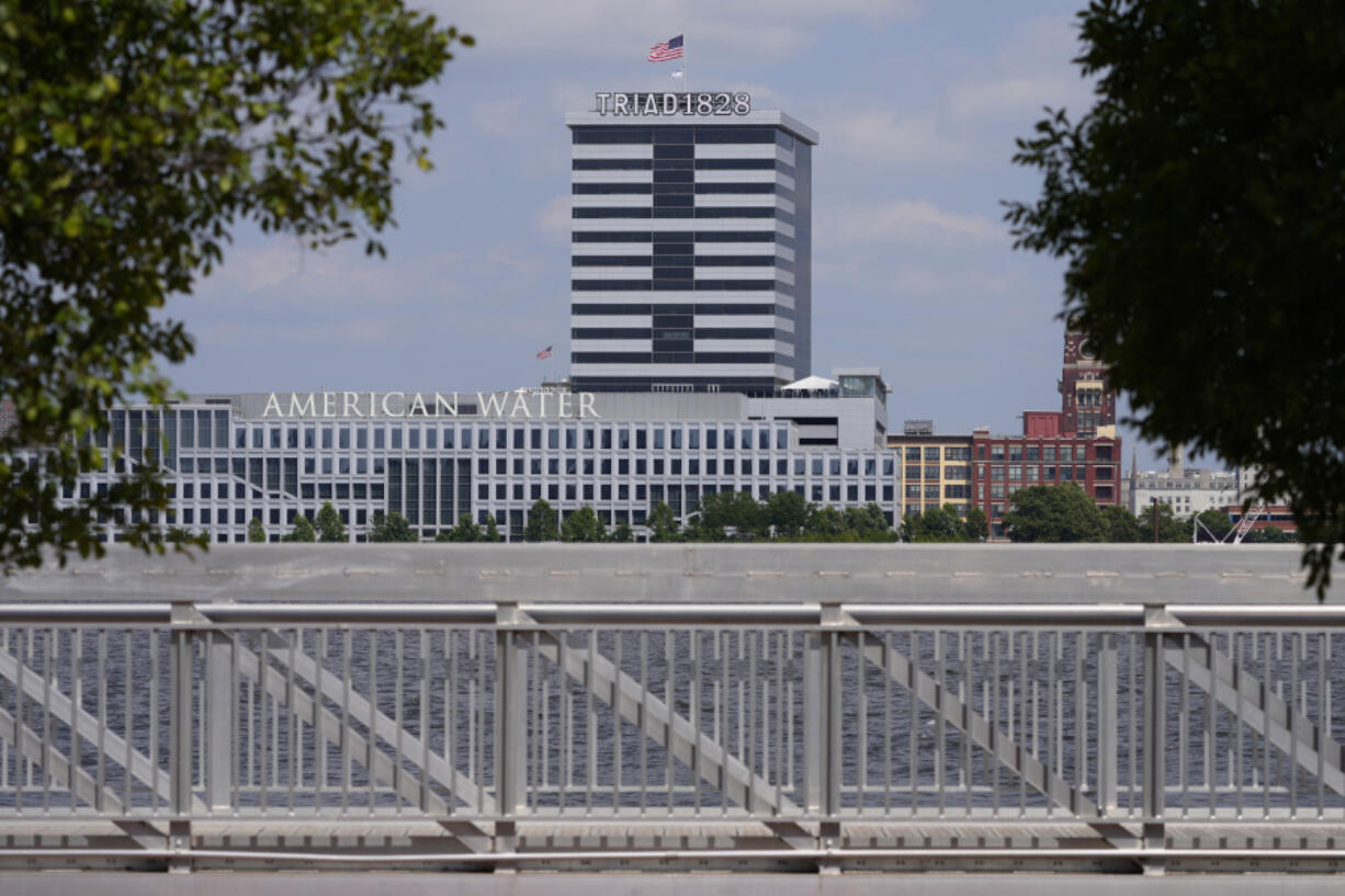 FILE - The largest regulated water and wastewater utility company in the U.S., American Water, its building in Camden, N.J., seen in the foreground on June 17, 2024, says it was the victim of a cyberattack, prompting the firm to pause billing to customers.