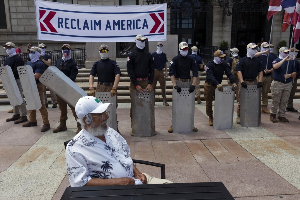 People bearing the insignia of the white supremacist group Patriot Front stand in front of the Boston Public Library in Copley Square on Saturday, July 2, 2022, in Boston.