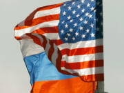 FILE - U.S. and Russian national flags wave on the wind in Moscow's Vnukovo airport, Russia, April 11, 2017 to welcome a U.S. dignitary.