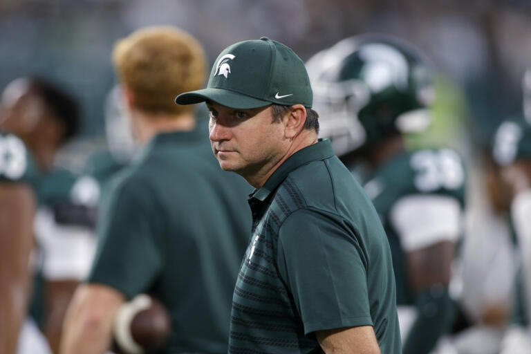 Michigan State coach Jonathan Smith watches warmups before an NCAA college football game against Ohio State, Saturday, Sept. 28, 2024, in East Lansing, Mich.