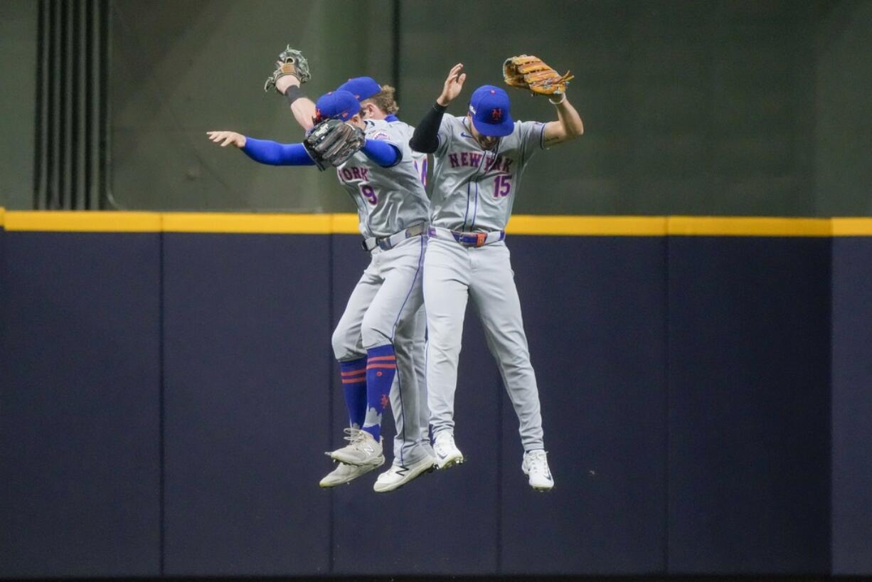 New York Mets' Brandon Nimmo, Harrison Bader, and Tyrone Taylor celebrate after Game 2 of a National League wild card baseball game against the Milwaukee Brewers Tuesday, Oct. 1, 2024, in Milwaukee. The Mets won 8-4.