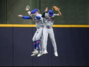 New York Mets' Brandon Nimmo, Harrison Bader, and Tyrone Taylor celebrate after Game 2 of a National League wild card baseball game against the Milwaukee Brewers Tuesday, Oct. 1, 2024, in Milwaukee. The Mets won 8-4.