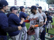 Detroit Tigers' Andy Ibanez (77) celebrates with the team and staff after their 5-2 win against the Houston Astros in Game 2 of an AL Wild Card Series baseball game Wednesday, Oct. 2, 2024, in Houston. (AP Photo/Kevin M.