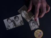 Yooree Kim, who was sent to a couple in France by the Holt adoption agency when she was 11, displays some old photos of her and her brother in her apartment in Seoul, Saturday, May 18, 2024. (AP Photo/Jae C.