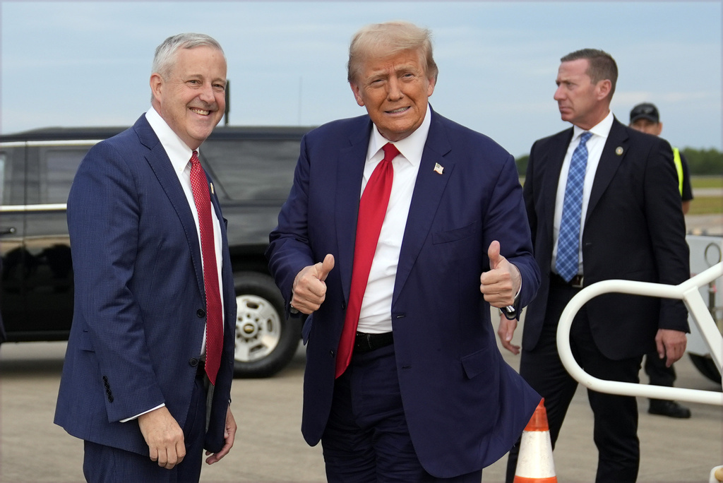 Republican presidential nominee former President Donald Trump stands with Republican National Committee chair Michael Whatley as he arrives at Fayetteville Regional Airport to attend a town hall, Friday, Oct. 4, 2024, in Fayetteville, N.C.