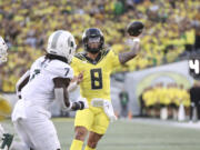 Oregon quarterback Dillon Gabriel (8) throws past Michigan State linebacker Jordan Turner (7) during the first half of an NCAA college football game, Friday, Oct. 4, 2024, in Eugene, Ore.