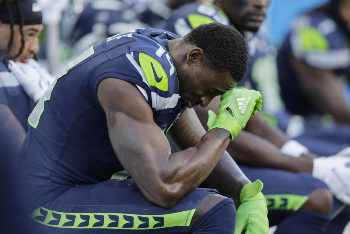 Seattle Seahawks wide receiver DK Metcalf (14) sits on the sideline during the second half of an NFL football game against the New York Giants, Sunday, Oct. 6, 2024, in Seattle.