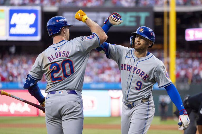 New York Mets' Brandon Nimmo, right, celebrates his home run with Pete Alonso, left, during Game 2 of a baseball NL Division Series against the Philadelphia Phillies, Sunday, Oct. 6, 2024, in Philadelphia.