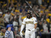 San Diego Padres' Fernando Tatis Jr. tosses his bat after hitting a two-run home run during the second inning in Game 3 of a baseball NL Division Series against the Los Angeles Dodgers, Tuesday, Oct. 8, 2024, in San Diego.