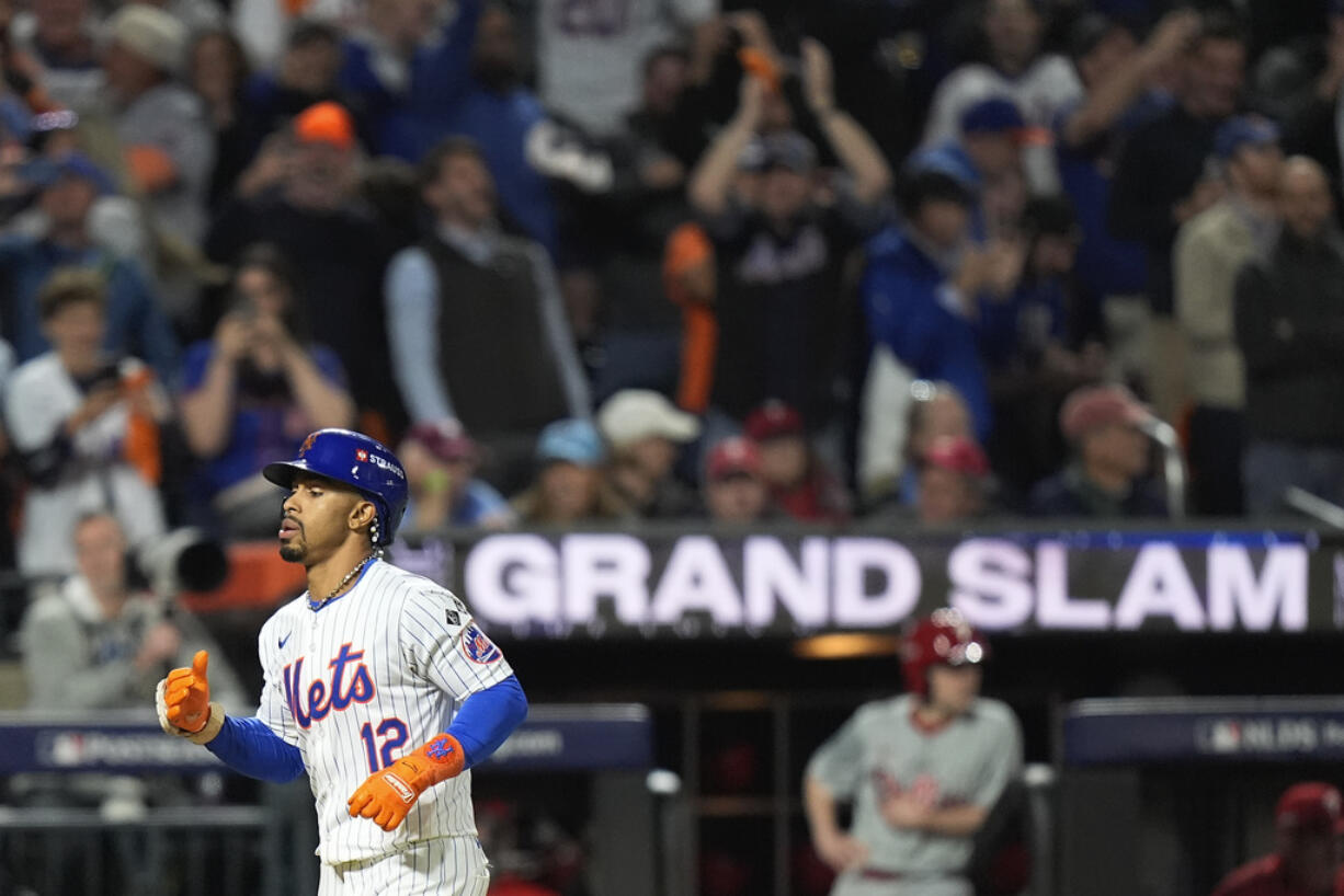 New York Mets' Francisco Lindor (12) rounds the bases after hitting a grand slam home run against the Philadelphia Phillies during the sixth inning of Game 4 of the National League baseball playoff series, Wednesday, Oct. 9, 2024, in New York.