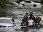 People are rescued from an apartment complex in the aftermath of Hurricane Milton, Thursday, Oct. 10, 2024, in Clearwater, Fla.