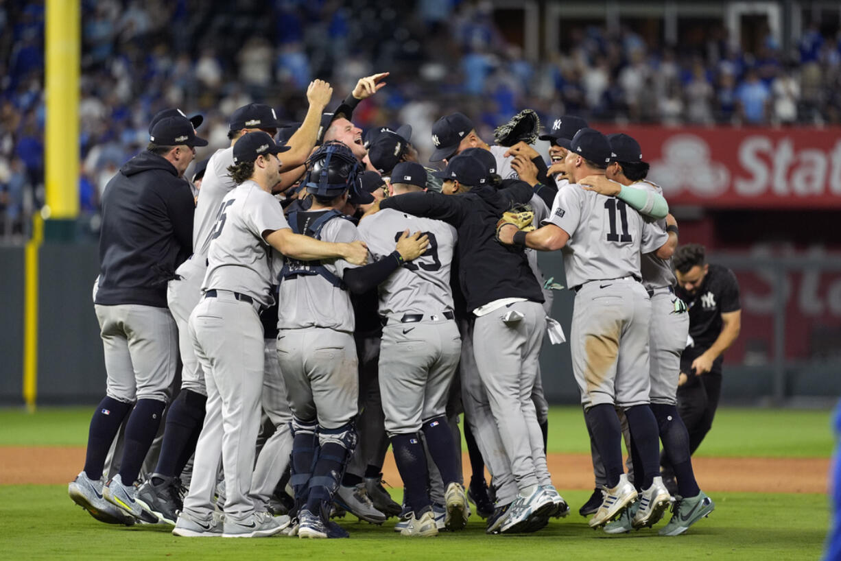 Members of the New York Yankees celebrate after defeating the Kansas City Royals 3-1 in Game 4 of an American League Division baseball playoff series and move on to the ALCS Thursday, Oct. 10, 2024, in Kansas City, Mo.