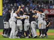 Members of the New York Yankees celebrate after defeating the Kansas City Royals 3-1 in Game 4 of an American League Division baseball playoff series and move on to the ALCS Thursday, Oct. 10, 2024, in Kansas City, Mo.