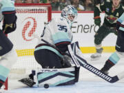 Seattle Kraken goaltender Joey Daccord (35) blocks a shot during the first period of an NHL hockey game against the Minnesota Wild, Saturday, Oct. 12, 2024, in St. Paul, Minn.