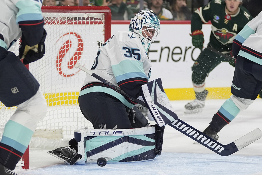 Seattle Kraken goaltender Joey Daccord (35) blocks a shot during the first period of an NHL hockey game against the Minnesota Wild, Saturday, Oct. 12, 2024, in St. Paul, Minn.