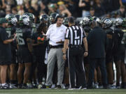 Oregon head coach Dan Lanning, center left, talks with a referee, center right, during an NCAA college football game against Ohio State, Saturday, Oct. 12, 2024, in Eugene, Ore.