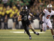 Oregon tight end Terrance Ferguson, left, runs the ball downfield against Ohio State safety Sonny Styles (6) during an NCAA college football game, Saturday, Oct. 12, 2024, in Eugene, Ore.