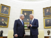 FILE - President Joe Biden, right, talks with Israeli Prime Minister Benjamin Netanyahu, left, in the Oval Office of the White House in Washington, July 25, 2024. U.S. officials say the Biden administration believes it has won assurances from Israel that it will not strike Iranian nuclear or oil sites as it looks to strike back following Iran’s missile barrage earlier this month. The officials, who spoke on condition of anonymity to discuss private diplomatic discussions, cautioned that the pledge is not iron-clad and that circumstances could change.