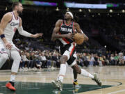 Portland Trail Blazers forward Jerami Grant (9) drives to the basket with Los Angeles Clippers center Ivica Zubac (40) defending during the first half of a preseason NBA basketball game, Friday, Oct. 11, 2024, in Seattle.