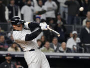 New York Yankees' Aaron Judge hits a two-run home run against the Cleveland Guardians during the seventh inning in Game 2 of the baseball AL Championship Series Tuesday, Oct. 15, 2024, in New York.