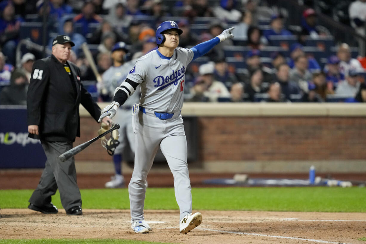 Los Angeles Dodgers' Shohei Ohtani celebrates his three-run home run against the New York Mets during the eighth inning in Game 3 of a baseball NL Championship Series, Wednesday, Oct. 16, 2024, in New York.