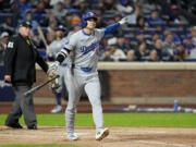 Los Angeles Dodgers' Shohei Ohtani celebrates his three-run home run against the New York Mets during the eighth inning in Game 3 of a baseball NL Championship Series, Wednesday, Oct. 16, 2024, in New York.