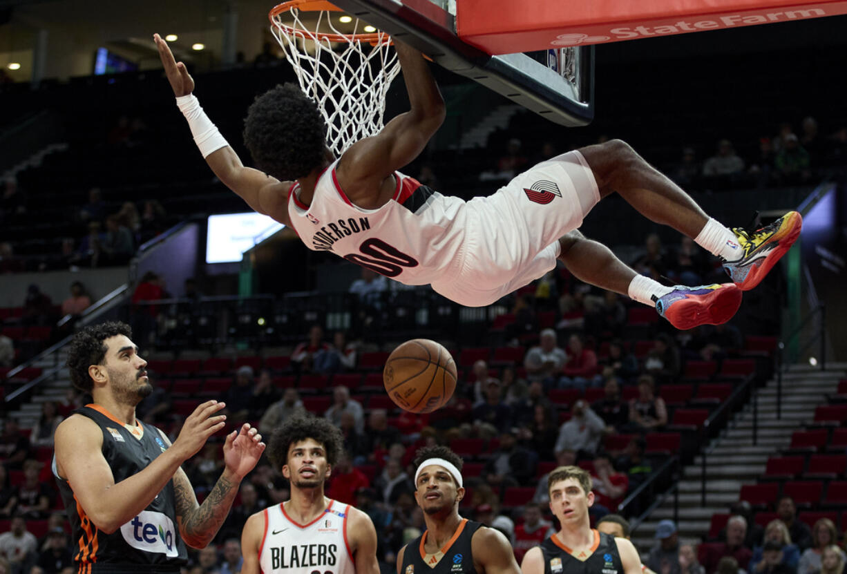 Portland Trail Blazers guard Scoot Henderson dunks during the second half of a preseason NBA basketball game against Ratiopharm Ulm in Portland, Ore., Wednesday, Oct. 16, 2024.