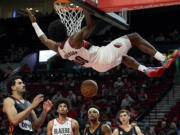 Portland Trail Blazers guard Scoot Henderson dunks during the second half of a preseason NBA basketball game against Ratiopharm Ulm in Portland, Ore., Wednesday, Oct. 16, 2024.