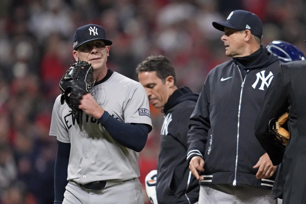 New York Yankees relief pitcher Ian Hamilton, left, leaves the game during the sixth inning in Game 3 of the baseball AL Championship Series against the Cleveland GuardiansvThursday, Oct.