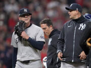 New York Yankees relief pitcher Ian Hamilton, left, leaves the game during the sixth inning in Game 3 of the baseball AL Championship Series against the Cleveland GuardiansvThursday, Oct.