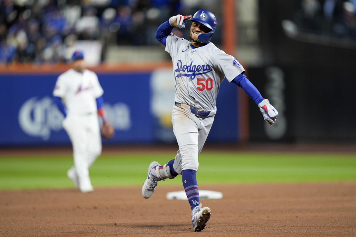 Los Angeles Dodgers' Mookie Betts celebrates after a two-run home run against the New York Mets during the sixth inning in Game 4 of a baseball NL Championship Series, Thursday, Oct. 17, 2024, in New York.