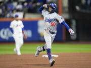 Los Angeles Dodgers' Mookie Betts celebrates after a two-run home run against the New York Mets during the sixth inning in Game 4 of a baseball NL Championship Series, Thursday, Oct. 17, 2024, in New York.