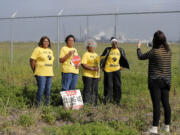 FILE - Members of RISE St. James conduct a live stream video, on property owned by Formosa, in St. James Parish, La., March 11, 2020.