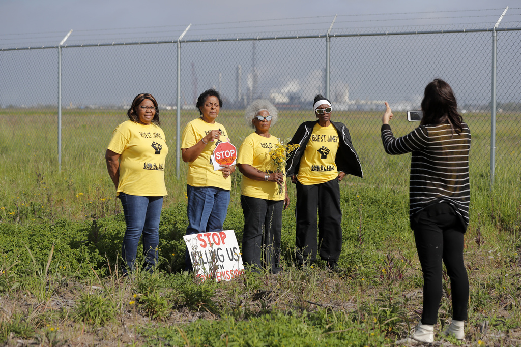 FILE - Members of RISE St. James conduct a live stream video, on property owned by Formosa, in St. James Parish, La., March 11, 2020.