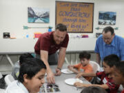 Trevor Cowling helps out during an activity class at a summer camp for youth at Valley Baptist Church Tuesday, June 18, 2024, in Mesa, Ariz. (AP Photo/Ross D.