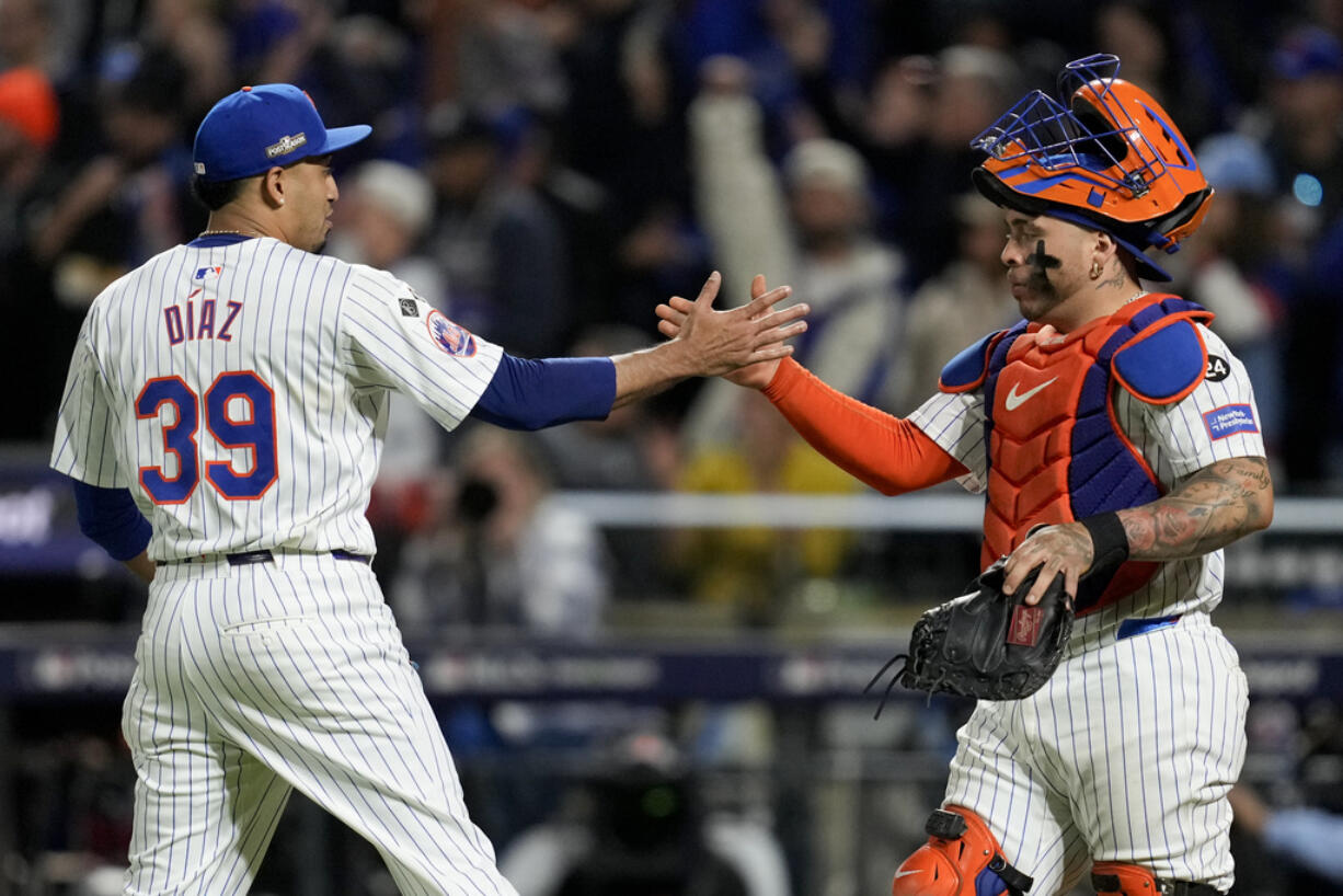 New York Mets pitcher Edwin Díaz and catcher Francisco Alvarez celebrates their win against the Los Angeles Dodgers in Game 5 of a baseball NL Championship Series, Friday, Oct. 18, 2024, in New York.