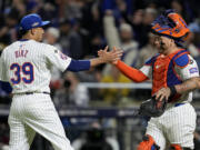 New York Mets pitcher Edwin Díaz and catcher Francisco Alvarez celebrates their win against the Los Angeles Dodgers in Game 5 of a baseball NL Championship Series, Friday, Oct. 18, 2024, in New York.