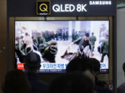 A TV screen shows an image of soldiers believed to be from North Korea stand in line to receive supplies from Russia during a news program at Seoul Railway Station in Seoul, South Korea, Monday, Oct. 21, 2024.